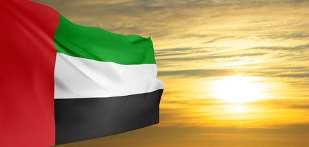 UAE flag on background of cloudy sunset or sunrise. Background for National Dayの写真素材