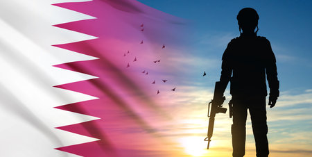 Silhouette of army soldier with Qatari flag on a background the sunset or the sunrise. Concept for...