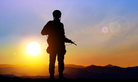 Silhouette of a solider against the sunsetのイラスト素材
