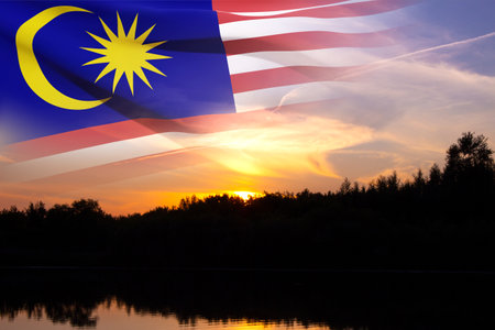 Flag of Malaysia against the sunsetの写真素材