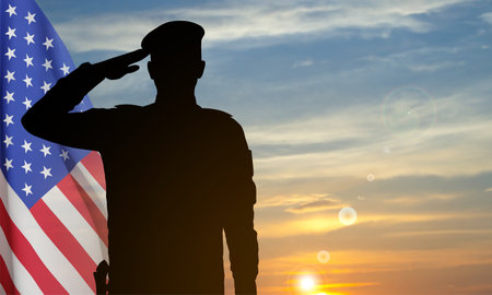 Silhouette of a soldier with USA flag against the sunset. Greeting card for Veterans Day, Memorial Day, Independence Day. vectorのイラスト素材