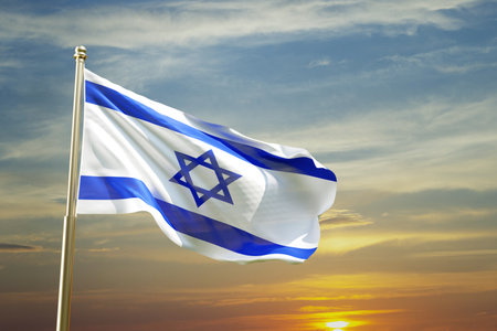 Israel flag with a star of David against the sunsetの写真素材