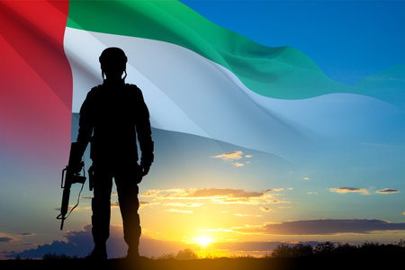 Silhouette of soldier with the flag of UAE against the sunset. Armed forces of United Arab Emirates. Concept for Commemoration Day, Martyrs Day, National Dayの写真素材