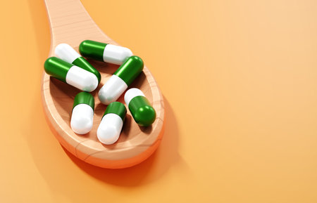 Pills on wooden spoon on orange background. Healthy and medicine concept. Pharmaceutical medicine pills or dietary supplement healthcare product. 3d-renderingの写真素材