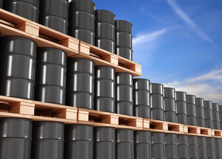 Black barrels on the pallets contain petroleum in warehouse prepare for deliveryの写真素材