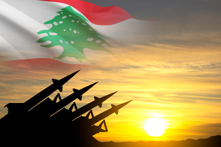 Lebanon missile launch. Silhouette of military missiles with Lebanon flag against the sunsetの写真素材