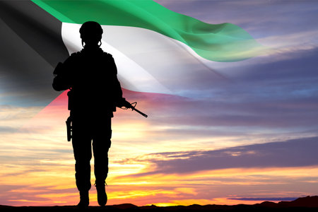 Silhouette of soldier with Kuwait flag against the sunset. Kuwait National Day. February 25-26.の写真素材