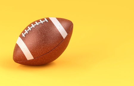 American football on yellow backgroundの写真素材
