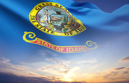 Flag of Idaho against the sunset sky, US stateの写真素材