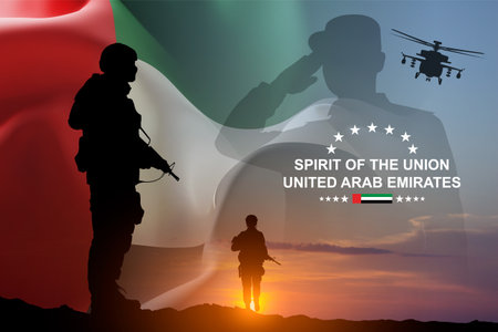 Silhouettes of soldiers with the flag of UAE against the sunset. Armed forces of United Arab Emirates. Concept for Commemoration Day, Martyrs Day, National Dayの写真素材