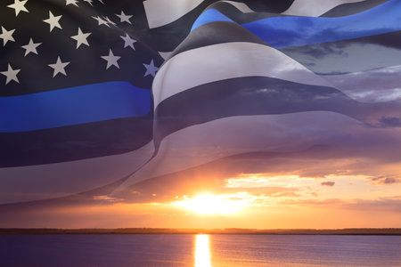 Thin Blue Line. Black Flag of USA with Police Blue Line against the sunset. National Law Enforcement Appreciation Day conceptの写真素材