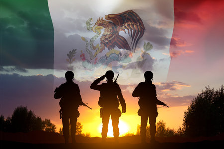 Silhouette of soldiers with Mexico flag against the sunset. National Holidays conceptの写真素材