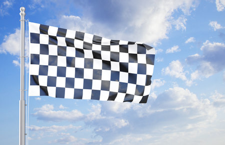 Checkered flag waving in the wind against the cloudy sky. Rally conceptの写真素材