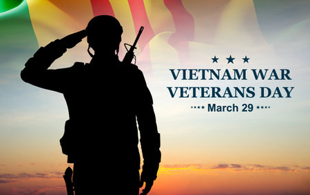 National Vietnam War Veterans Day. Celebrated in March 29th in USA. Vietnam campaign ribbon flag with silhouette of a soldier against the sunsetの写真素材