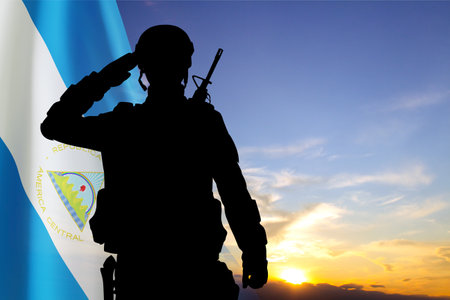 Silhouette of a soldier against the sunset with Nicaragua flag. National Holidays conceptの写真素材