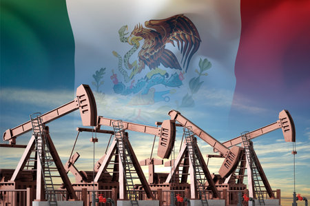 Oil pumpjacks with Mexico flag on background of skyの写真素材