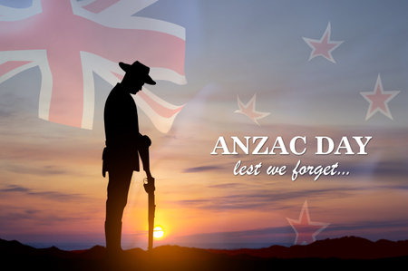 Silhouette of soldier paying tribute against the sunset with New Zealand flag. Anzac Day concept. Lest We Forgetの写真素材