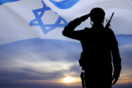 Silhouette of soldier against the sunset with Israel flag. National Holidays conceptの写真素材
