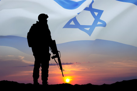 Silhouette of soldier against the sunset with Israel flag. National Holidays conceptの写真素材