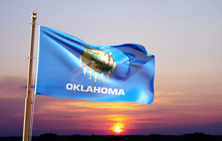 Flag of Oklahoma waving in the wind against the sunset. U.S. stateの写真素材