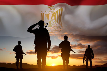 Silhouettes of soldiers against the sunset with Egypt flag. National Holidays conceptの写真素材