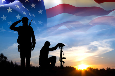 Silhouettes of a soldiers with USA flagの写真素材