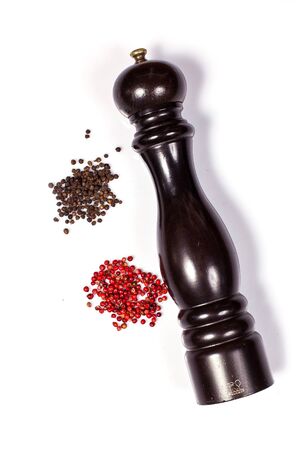 Pepper mill with black and red peppercorn isolated on white background.の写真素材
