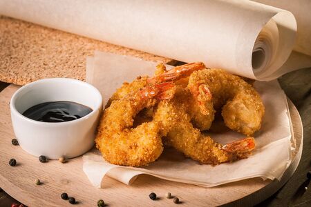 Deep Fried Shrimps on wooden board and baking paper.の写真素材