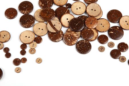 Wooden button on white backgroung with sapce for text.