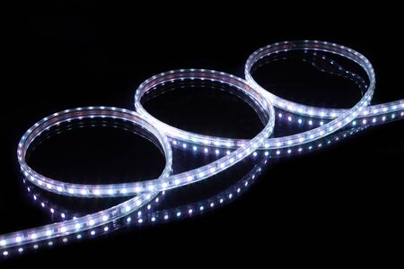 Cold white LED strip tape on black backgroundの写真素材