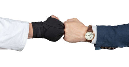 Businessman in suit handshake with judoka boxing gloves in white kimono isolated.