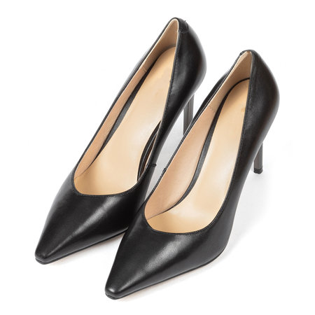 Black women's classic shoes with a sharp toe with thin heels on a white background.の写真素材