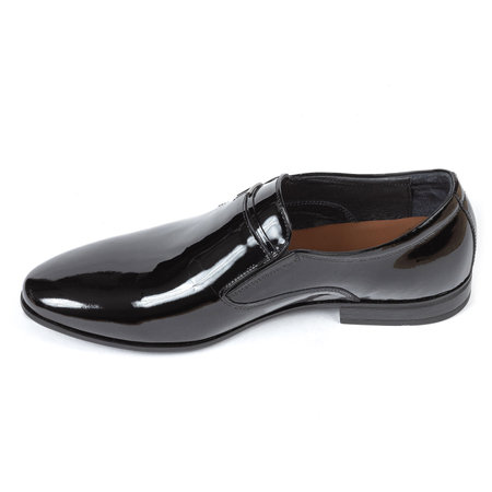 Black leather classic glossy shiny men's shoes without laces with a brown insole with low heels on a white background.の写真素材