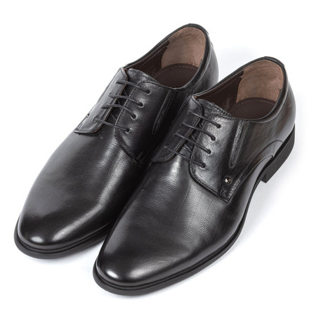 Black leather men's classic boots with thin black laces with thin heels on a white background.の写真素材