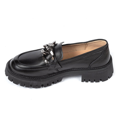 Black women's leather ankle boots on a thick rubber sole decorated with a metal chain on a white background.の写真素材
