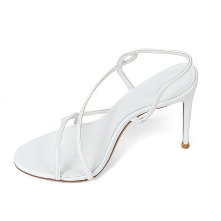 Fashionable White Leather Women's Sandals Shoes with Thin High Heels with Straps on White Background.の写真素材