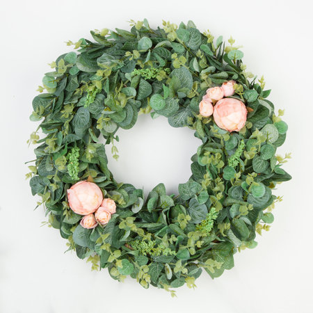 Beautiful green coniferous wreath made of natural materials top view on a white background.の写真素材