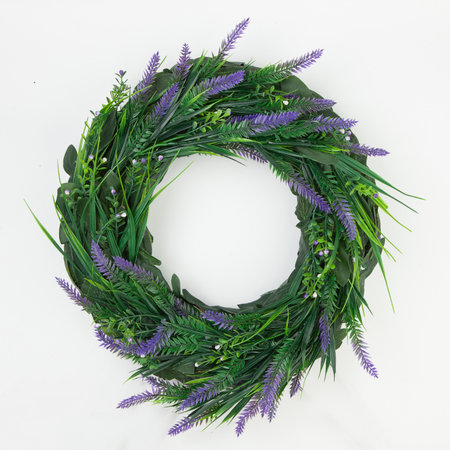 Beautiful green coniferous wreath made of natural materials top view on a white background.の写真素材