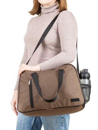 Young woman with sport bag in hand isolated white background.の写真素材