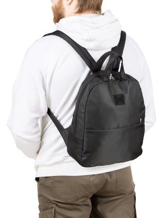 Young man with small balck backpack isolated on white background.の写真素材