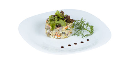 A pristine white plate that is beautifully topped with a fresh salad arranged artistically on a clean white background for emphasisの写真素材