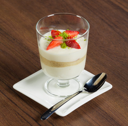 Strawberry dessert in glass on brown table.の写真素材