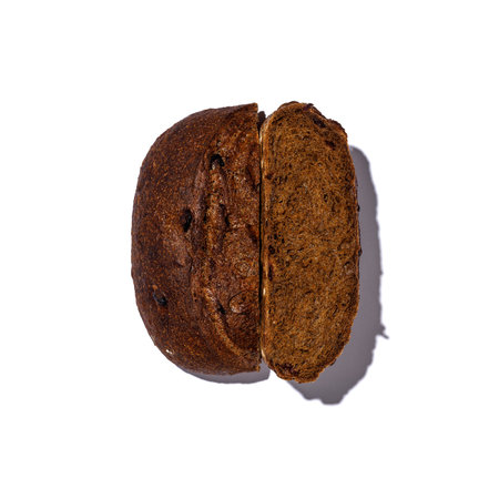 This image showcases a closeup view of a perfectly sliced piece of bread set against a clean, bright...