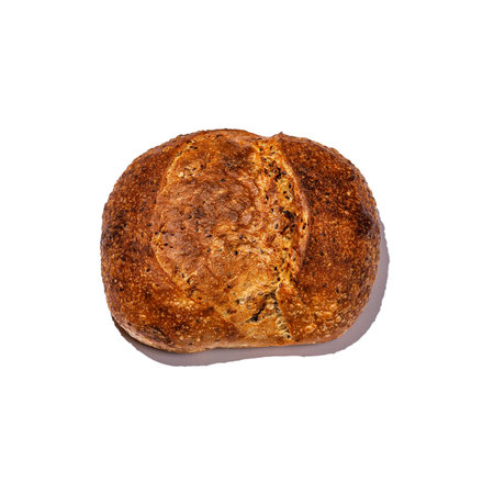 This is a close up image of a delicious loaf of bread displayed against a plain white background,...