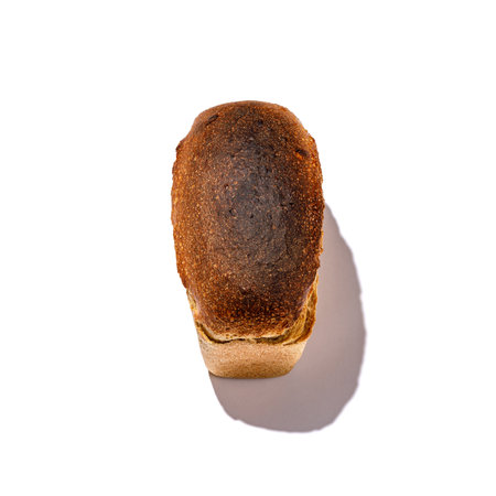 Here is a detailed closeup photograph of a delicious piece of bread prominently displayed on a...