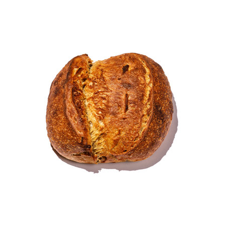 A closeup photograph of a baked loaf with a bite taken out of it, beautifully displayed against a clean white backgroundの写真素材