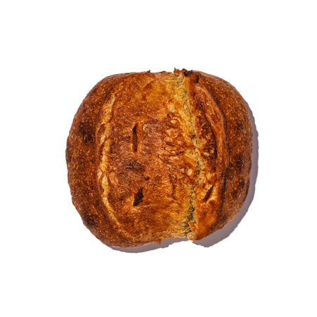 This is a closeup photo of a delicious cookie that has had a bite taken out of it, set against a clean white backgroundの写真素材