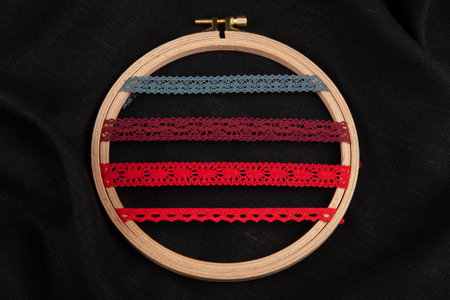 Set of red sewing ribbons on hoop over black backgroundの写真素材