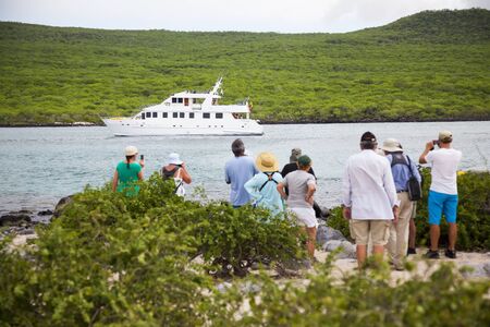 A group of tourists waiting to be embarked on his yacht, Lobos Island, Galapagosのeditorial素材