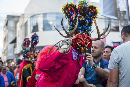 PÃ­llaro, ECUADOR - FEBRUARY 6, 2016: Unknown locals dressed up participating in the Diablada, popular town celebrations with people dressed as devils dancing in the streetsのeditorial素材